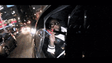 a man is smoking a cigarette in a car