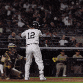 a batter with the number 12 on the back of his jersey