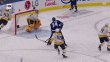 a hockey game is being played in front of an lg and esso advertisement