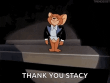 jerry from tom and jerry is standing on a stage in front of a microphone .