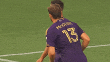 a group of soccer players including mcguire and thorhallsson celebrate a goal