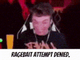 a man wearing headphones is making a funny face with the words `` ragebait attempt denied '' written below him .