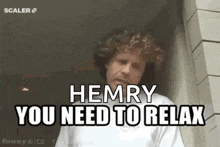 a man with curly hair is standing in front of a building and says `` henry you need to relax '' .