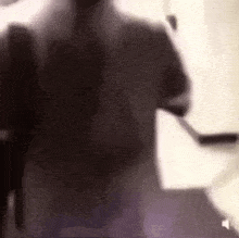 a blurry picture of a person walking down stairs with a hockey stick .