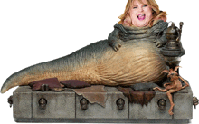a statue of jabba the hutt with a woman sitting on it