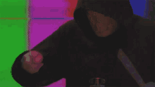 a man in a hooded sweatshirt with the letter d on the front