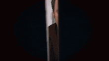 a person wearing a watch is holding a piece of paper