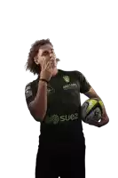 a man holding a rugby ball wearing a shirt that says suez