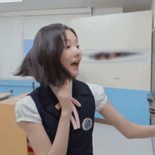 a girl in a school uniform has a button on her chest that says ' a '