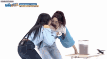 two women are laying on the floor with korean writing on the bottom of the screen