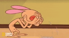 a cartoon character is covering his face with his hands while laughing .