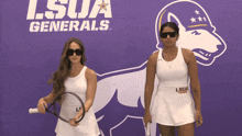 two women standing in front of a lsua generals logo