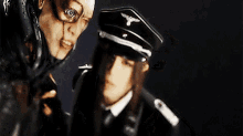 a man and a woman are standing next to each other in a dark room .