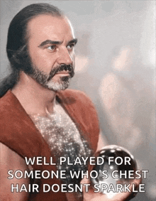 a man with a beard and long hair is holding a ball in his hand and a quote .
