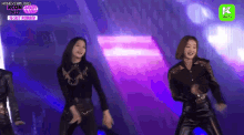 a group of women are dancing on a stage with a sign that says secret number .