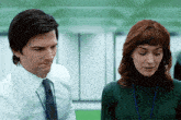 a man and a woman are looking at each other