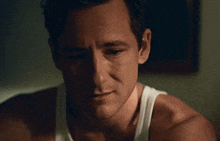 a close up of a man 's face with a tear running down his cheek .