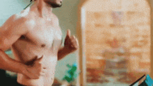 a shirtless man is running on a treadmill without a shirt .
