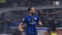 a man in a blue and black jersey with betsson on it