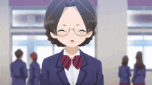 a girl with glasses and a bow tie stands in a classroom