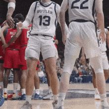 a basketball player wearing a butler 13 jersey