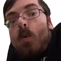 a man with glasses and a beard makes a funny face
