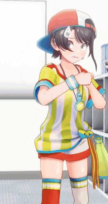 a girl in a striped shirt and hat is standing in a room .