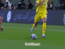 a soccer player leaps over another player with the hashtag ettigoat
