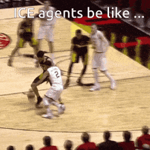 a basketball player with the number 2 on his jersey is dribbling the ball