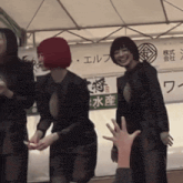 a woman with red hair stands in front of a sign that says ' elf ' on it