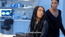 two women are standing in a room and one of them is saying you 're free to go home