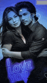 a man and woman hugging with a neon sign that says i love you in the background
