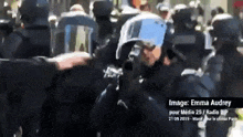 a group of police officers are standing in a crowd with the date 21 09 2013