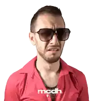 a man wearing sunglasses and a red shirt with mcdh written on it