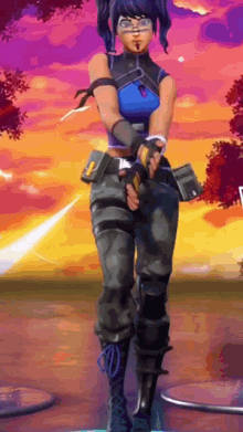 a woman in a blue top and black pants is standing in front of a sunset .