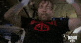 a man wearing a tapout shirt is lifting weights