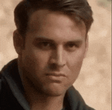 a close up of a man 's face looking at the camera