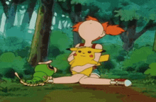 a girl holding a pikachu and a green caterpillar