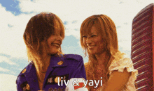 a couple of women standing next to each other with the words liv & yayi written on the bottom