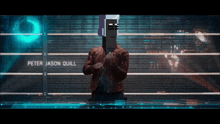 peter jason quill is standing in front of a fence