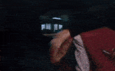 a close up of a woman 's face in a dark room with a blurry background .