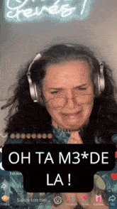 a woman wearing headphones and glasses says oh ta m3 * de la !