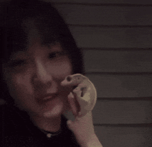 a close up of a woman holding a frog in her hand