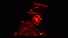 a soldier with a skull painted on his face wears a helmet