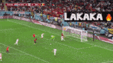 a soccer game is being played on a field sponsored by qatar