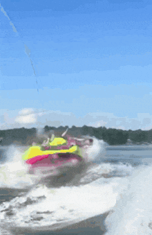 a person is riding a colorful raft in the water