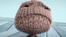 a stuffed animal with a sad face on it