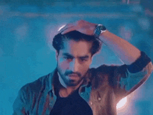 a man with a beard is wearing a watch on his wrist .