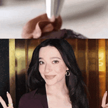 a woman with a ring on her finger is smiling in front of a wall