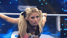 a woman in a wrestling ring with the letters w on the bottom